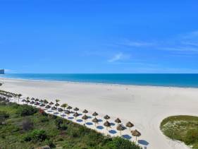 Sunny beachfront condo with pool and SW-facing balcony