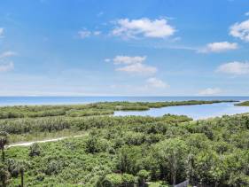 Alluring beachfront condo with pool and view of lagoon