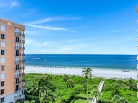 Beachfront condo building with pool, tennis and views