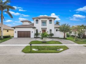 Exquisite waterfront Home featuring a pool and hot tub
