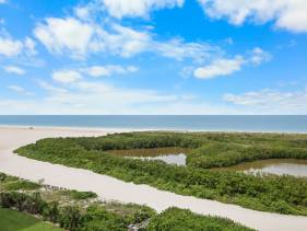 Beachfront condo with pool and balcony facing beach