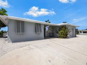 Home on water with pool/lanai kitchen/walk to beach