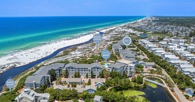 Aerial view of beachfront community with pristine white sand beaches and emerald waters along the Gulf Coast