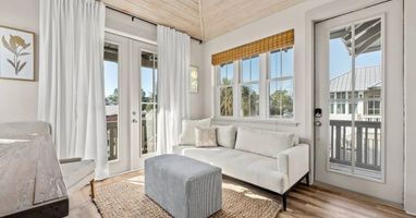 Kick back on the sofa as light pours through the French doors.