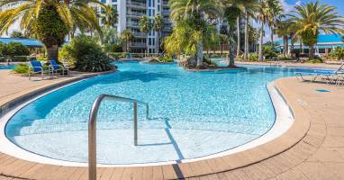 Resort-style pool framed by swaying palms, perfect for sunny afternoons & cooling off between beach days