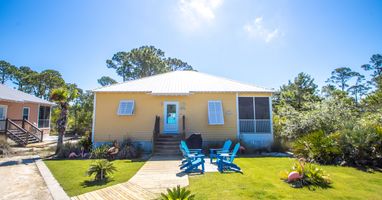Front of Cottage, parking to the Left of wood sidewalk