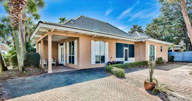 Real Sandy exterior with private driveway and beautifully maintained coastal landscaping