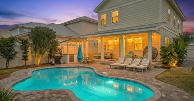 Heated pool, patio, and backyard at dusk—perfect for evening swims and outdoor entertaining.