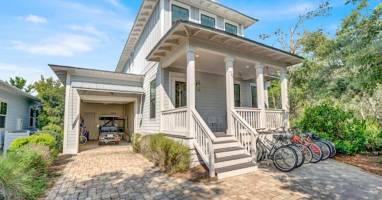 Front of house with parking for 3 vehicles.  A 6 seater golf cart and 8 full size bikes