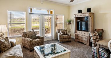 Spacious living room leads out to large screened in porch