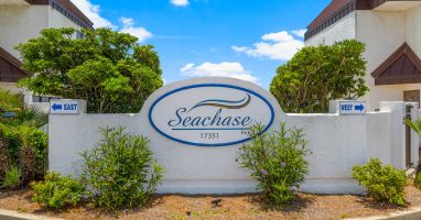 ENTRANCE VIEW SEACHASE SIGN. DRIVE IN BETWEEN EAST AND WEST BUILDINGS  
