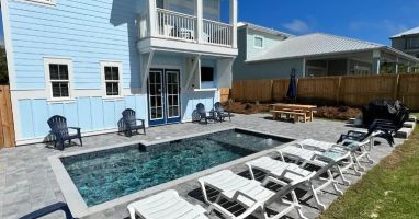Additional view of the back yard/patio at "Sunseeker"! Complete with a 60" TV for watching the game or a family movie around the pool at nighttime!