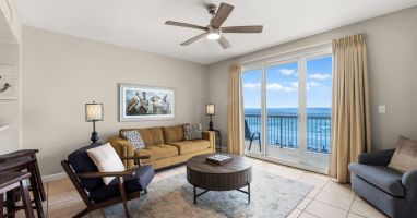 Beachfront living room with ocean-view balcony and coastal furnishings