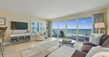 Bright beachfront condo in Destin, FL featuring private balcony access and panoramic Gulf scenery.