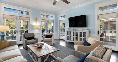 Unwind in your bright, airy living room with French doors opening to private balconies and comfortable seating for memorable moments.