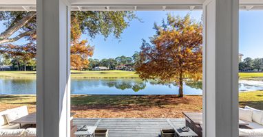 Step onto your private covered patio and soak in breathtaking lake views framed by golden autumn trees.