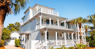 Bright 3-story home with separate carriage house, multiple porches and walkable access to the beach, pool, green space, restaurants and shops.