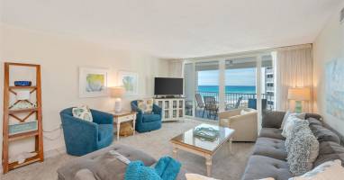 Sink into plush seating while ocean waves fill your view through floor-to-ceiling windows on your private balcony.