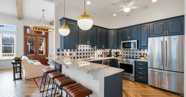 Your gourmet kitchen features navy cabinets, granite counters, and a breakfast bar where you'll savor morning coffee.