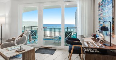 Your oceanfront retreat features floor-to-ceiling windows framing stunning sea views from your stylish living space.