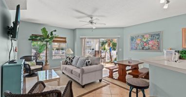 Sink into the plush sofa and enjoy your tropical oasis with calming décor, modern amenities, and peaceful balcony views.