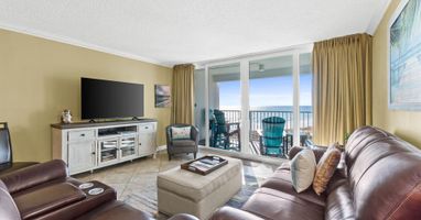 Sink into plush leather seating while enjoying breathtaking ocean views from your private balcony through floor-to-ceiling windows.