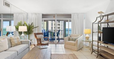 Relax in your bright coastal living room where ocean breezes flow through sliding doors to your private balcony overlooking stunning sea views.