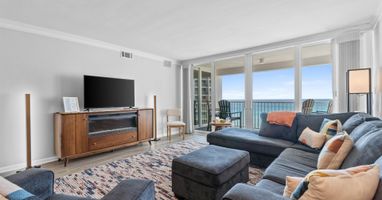 Unwind in your elegant living room with stunning ocean views through floor-to-ceiling windows. Sink into the plush sectional and enjoy your perfect coastal retreat.