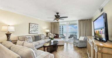 Relax in your elegant living room with plush seating and stunning ocean views from your private balcony.