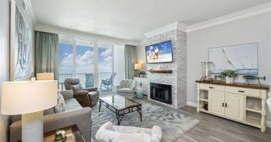 Unwind in your elegant living room with stunning ocean views, cozy fireplace, and coastal-themed décor perfect for relaxing after beach days.