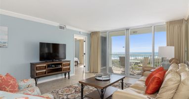 Unwind in your bright living room with ocean views, plush seating, and coastal charm perfect for relaxing after beach days.