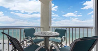 Sip your morning coffee while watching waves crash below from this oceanfront balcony with comfortable seating.