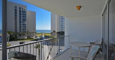 Relax on your private balcony with ocean glimpses between coastal towers, perfect for morning coffee or sunset cocktails.