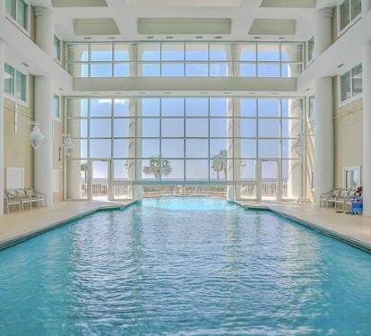 Indoor/outdoor heated pool w/ tall windows for year-round swimming.