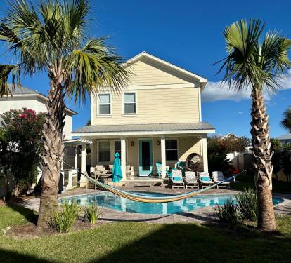 Daytime view of the private backyard with pool and outdoor seating.