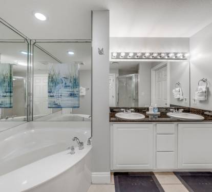 Large tub and walk-in shower with dual vanities