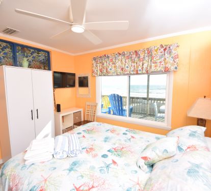 beachside bedroom with queen bed