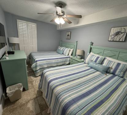 This bedroom has two queen sized beds.