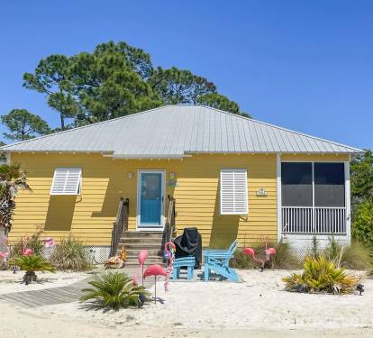 Front of Cottage, parking to the Left of wood sidewalk