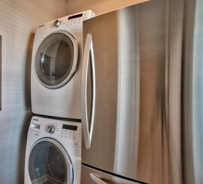 Laundry room with full-size fridge