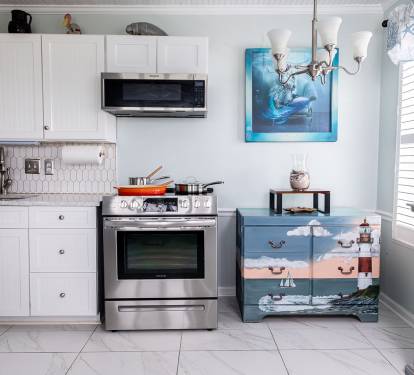 The full kitchen is finished with quartz countertops and includes a stove and oven, microwave, full refrigerator and freezer, and storage for dry goods. Whether you’re cooking dinner or keeping things simple, everything you need is within reach.