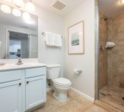 Spacious bathroom w/ walk-in shower, neutral finishes, and a bright, airy feel.