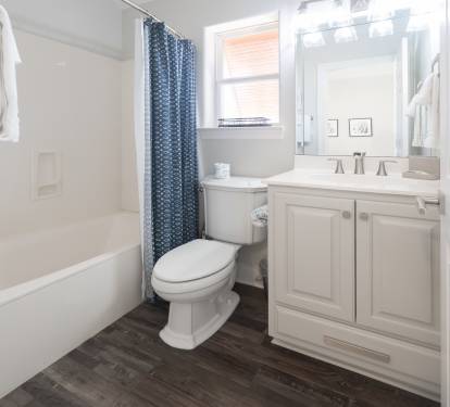 Bright bathroom w/ a clean sink and fresh, modern feel.