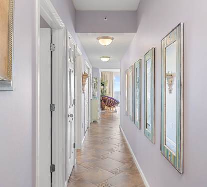 Hallway leading through the condo w/ crisp walls & an open, airy feel.