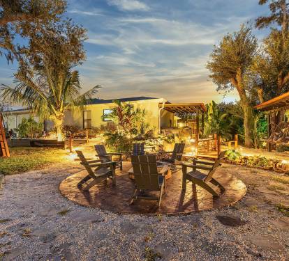 Cozy up by the firepit and enjoy the peaceful charm of the side yard.