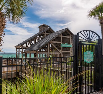 Beach pavilion and gated walkway to the Gulf