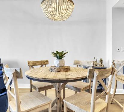 Gather around the table in this warm, coastal-inspired dining space—perfect for family meals, game nights, and planning your next beach day.