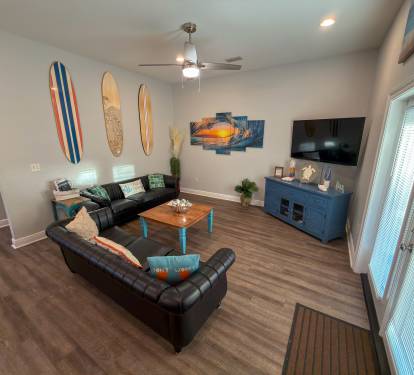 Oversized seating and surf-inspired accents bring a peaceful yet elevated beach-house feel to the living space.