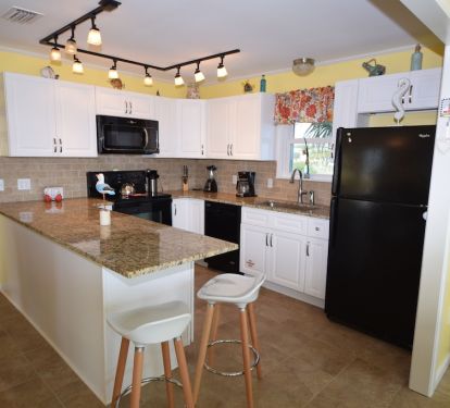 Spacious, fully stocket kitchen with granite count