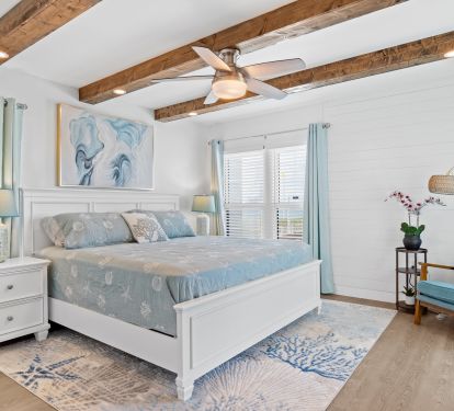 Main bedroom has a king bed and a comfortable chair for reading